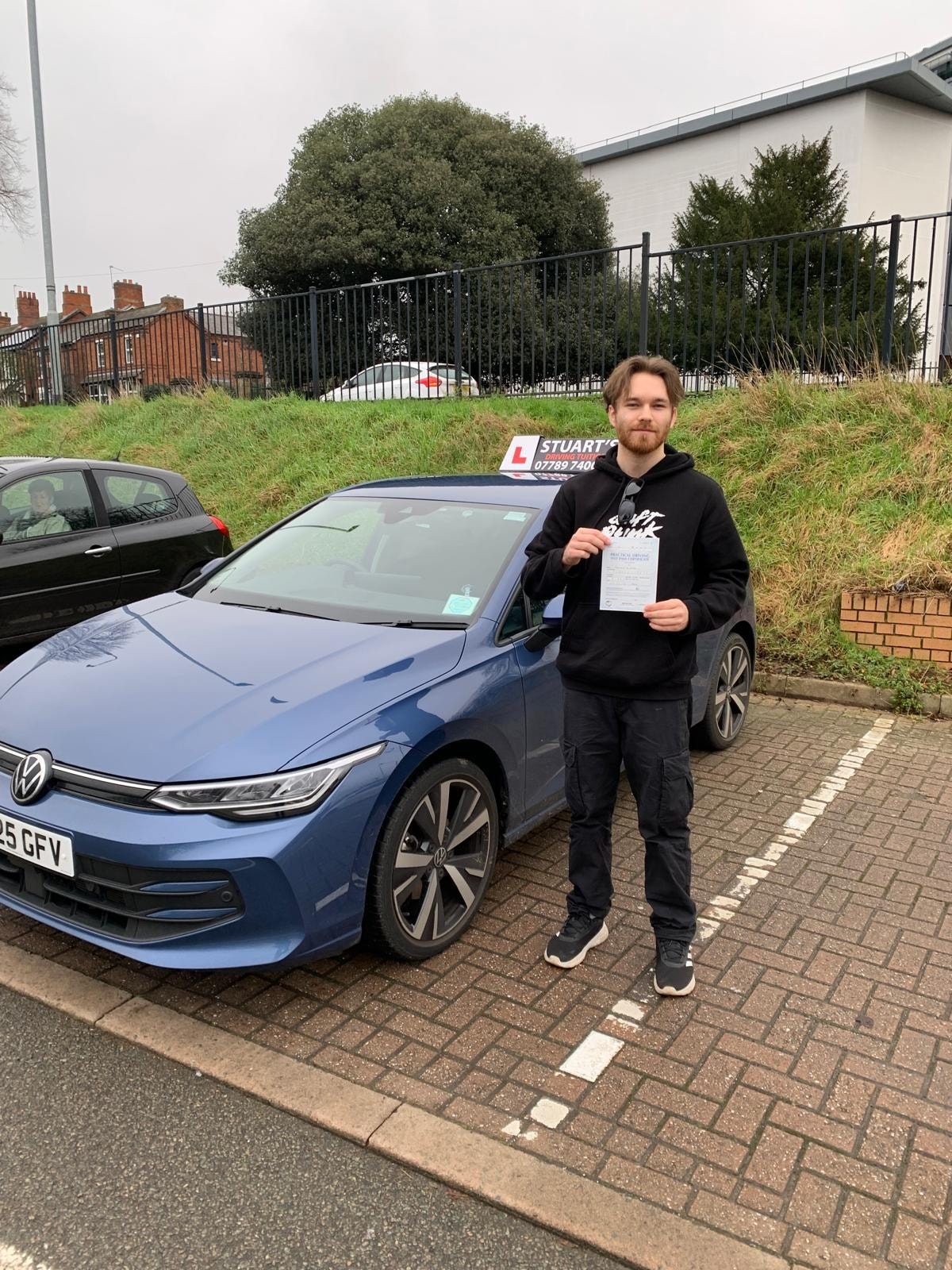 Driving instructor with learner driver during a manual driving lesson